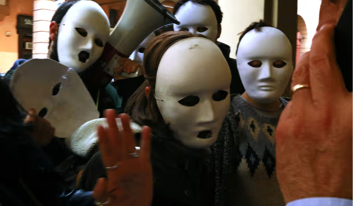 Horrible bosses: masked activists publicly shame businesses in Bologna